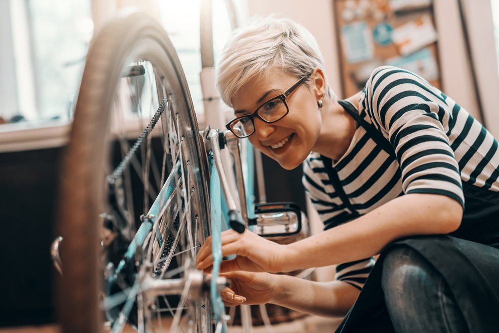 Woman fixing bike